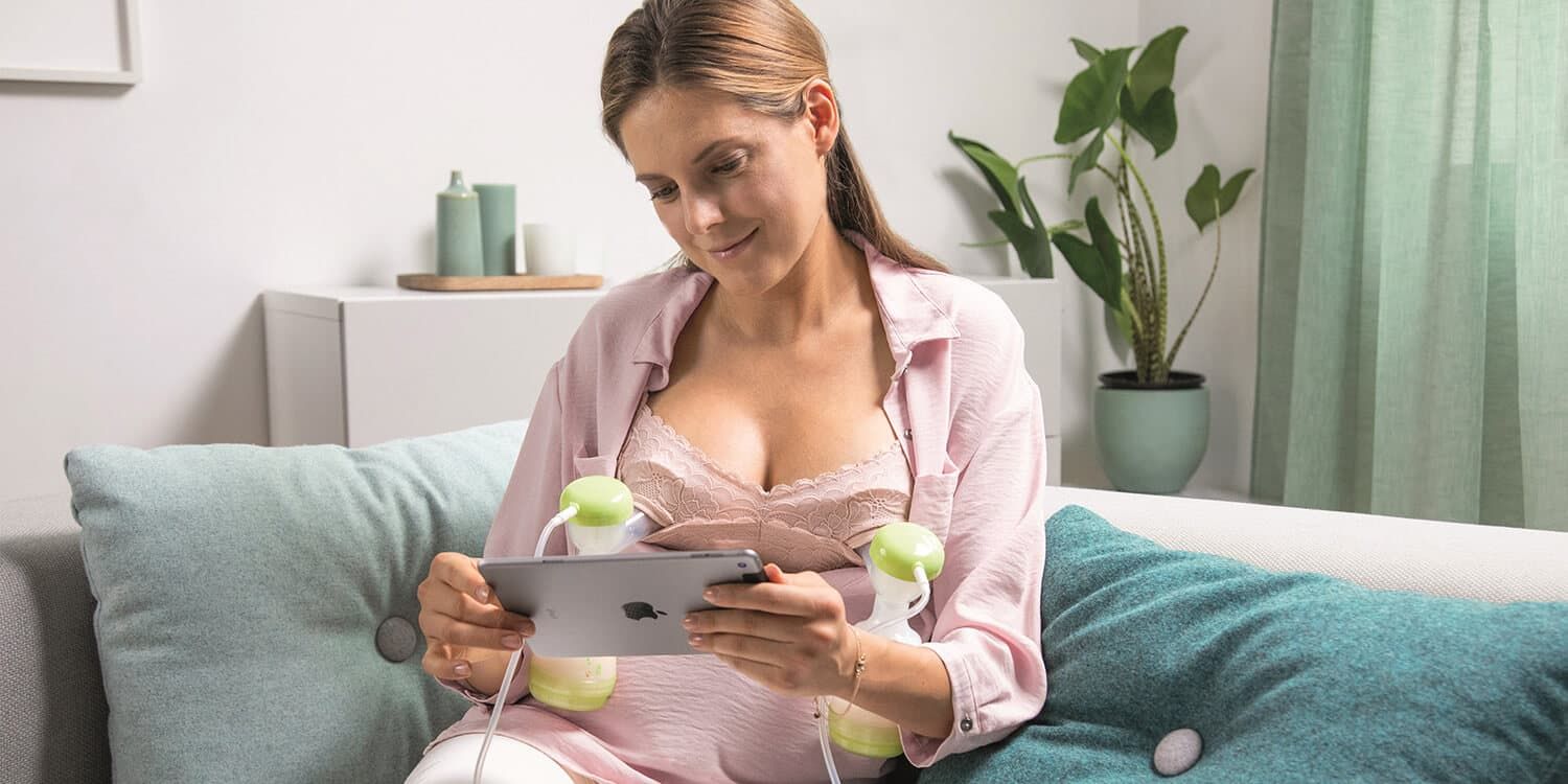 Woman pumps milk with MAM 2in1 double breast pump