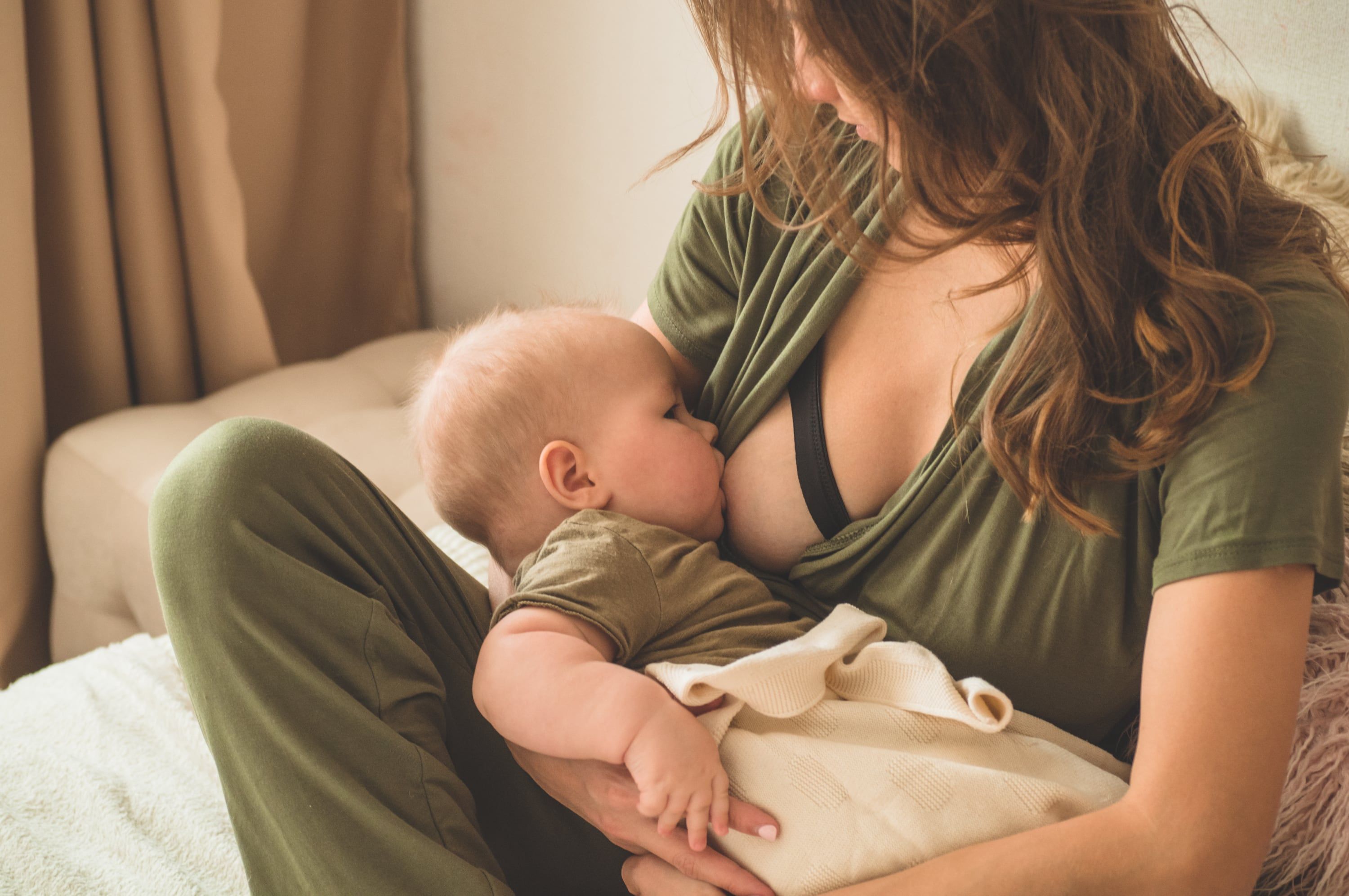 mother breastfeeds her baby